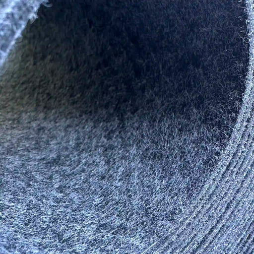 High Flow conveyor belt for Zund cutting systems, close-up of rolled felt belt material showing the gray and black fiber surface